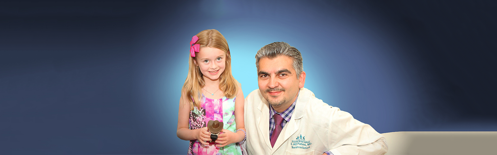 Dr. Ali Fatemi and a patient smiling.