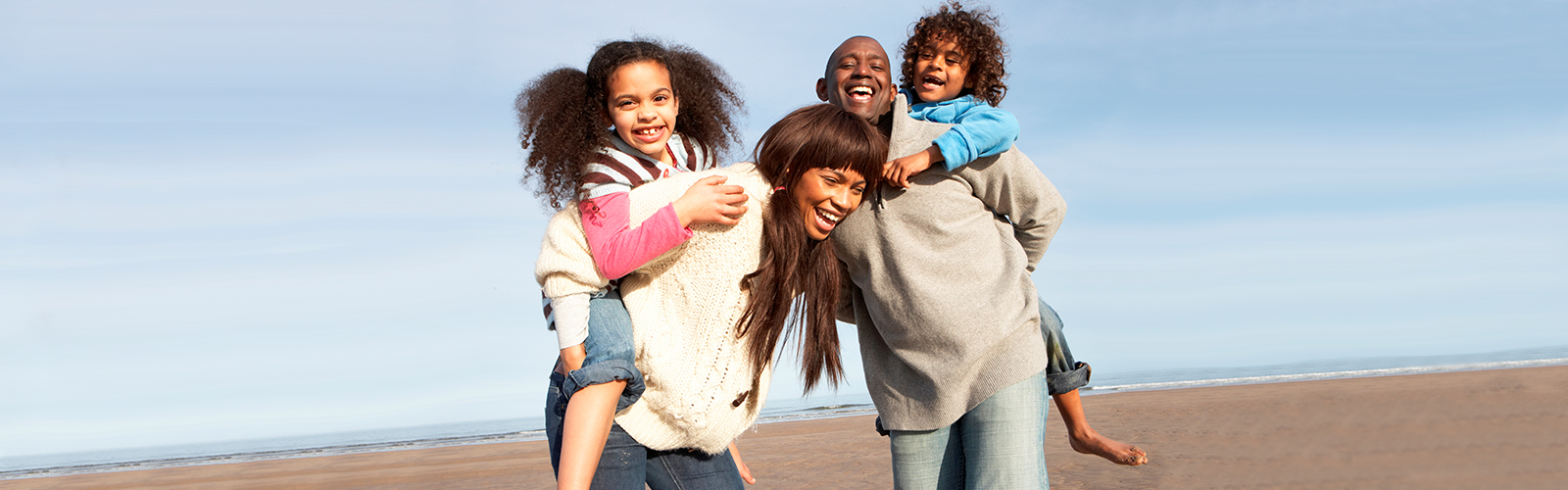 A happy family together on a beach.