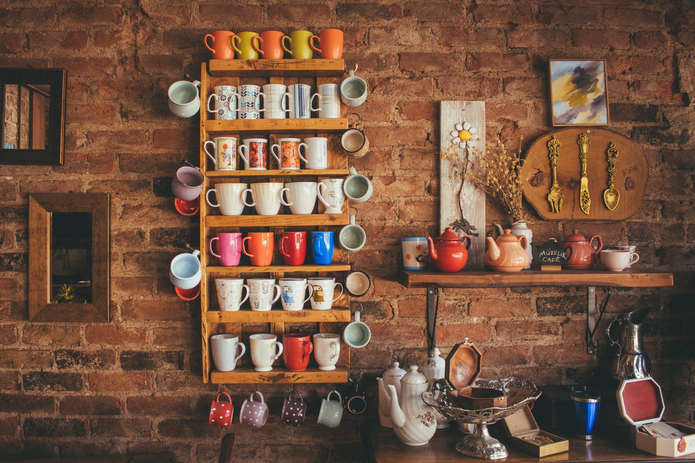 Mugs, teapots, and an assortment of other painted pottery