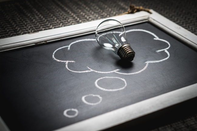 A chalkboard with a lightbulb on it