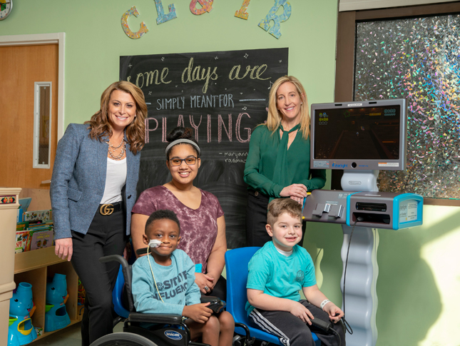 Members of WIN pose with Kennedy Krieger patients