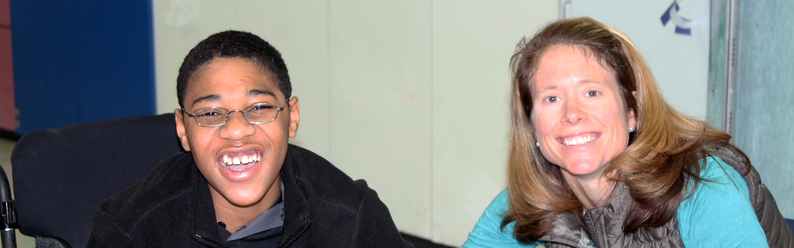 A WIN member poses with a patient during a volunteer event