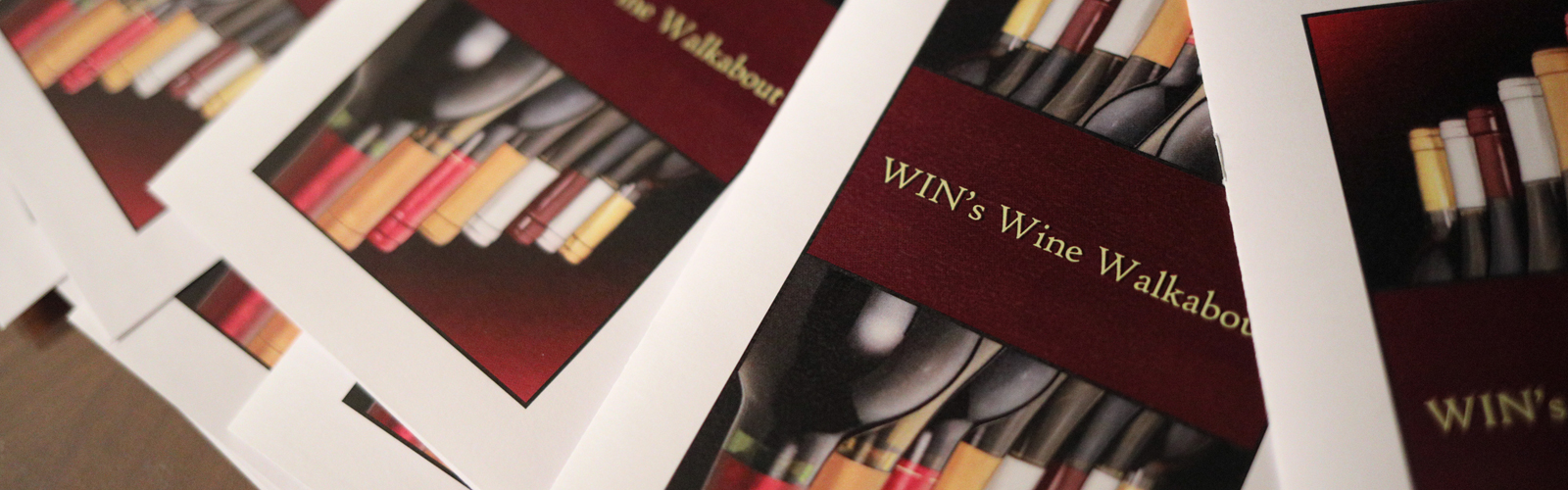 A photograph of Wine Walkabout programs from a previous Wine Walkabout event