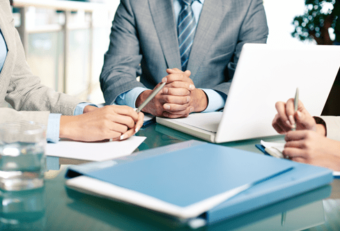 A stock image of employees sitting at a desk