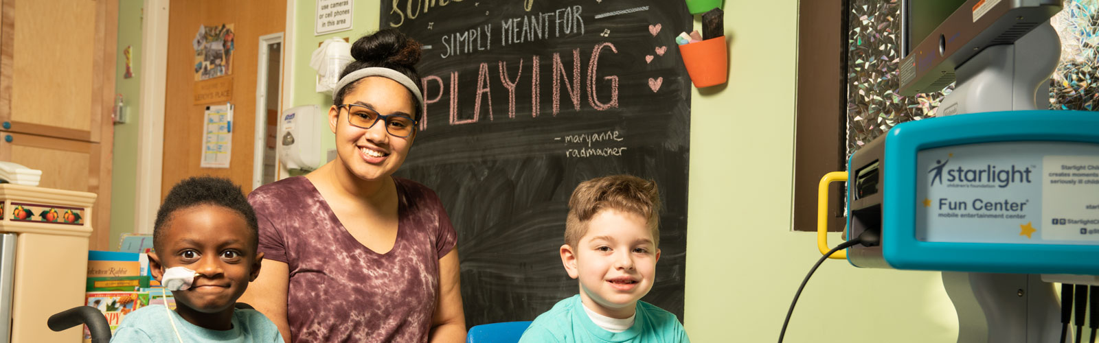 Two children and a woman enjoy using the Starlight Fun Center.