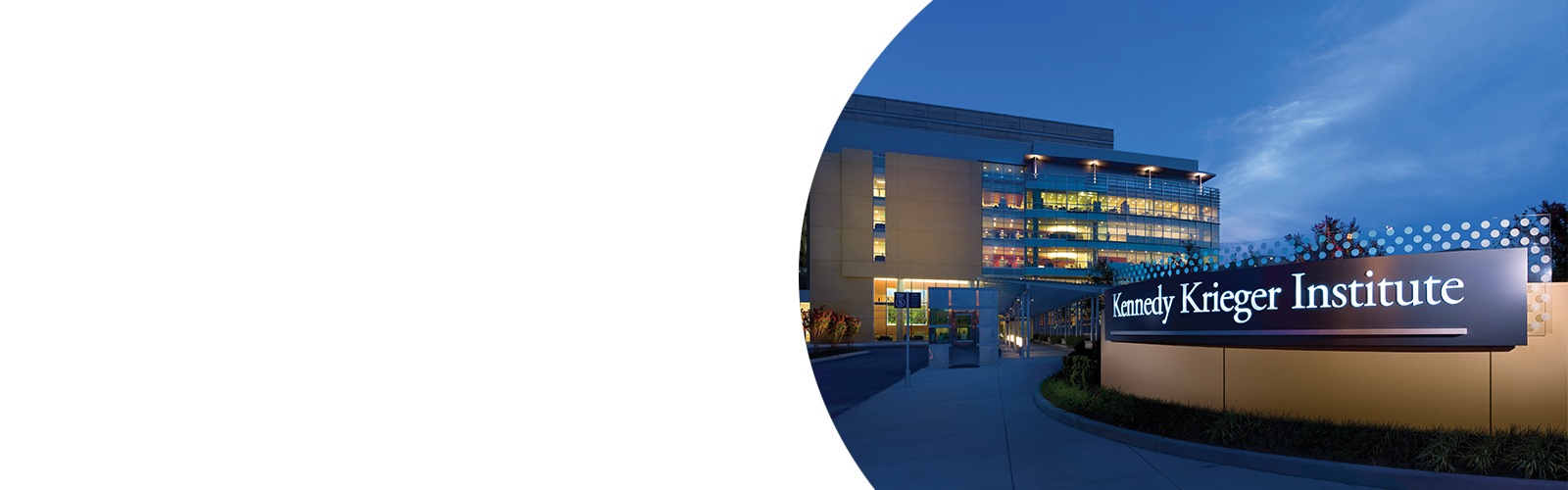 Exterior of Kennedy Krieger's main outpatient building at night.