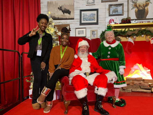 Volunteer pose with Santa at Festival of Trees 2025