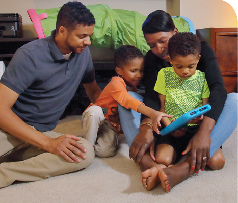 Left to right: Gill, Myles, Gina and Dale, who has autism and uses an iPad tablet as one medium of communication.