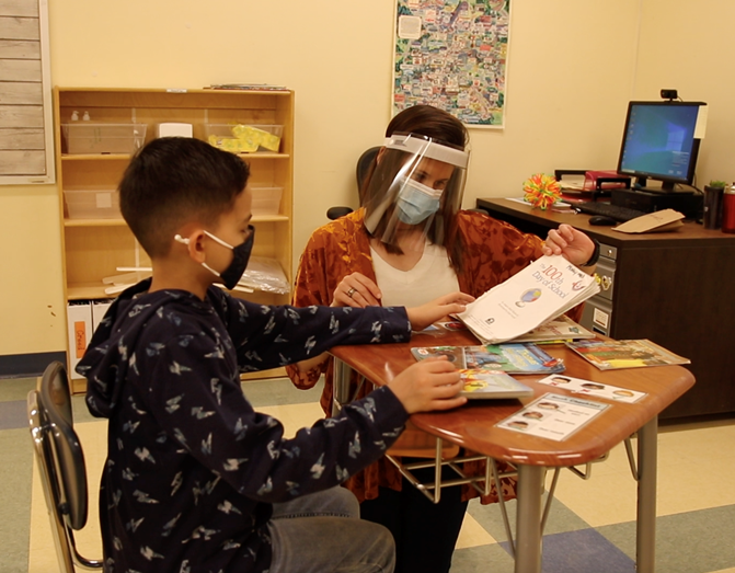 Creed, a student at our Fairmount School, with a teacher