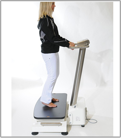 A woman standing on a vibration plate.