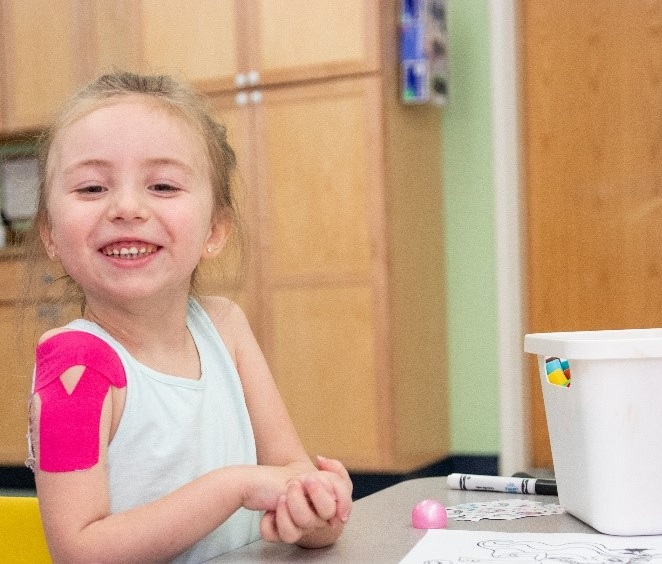 A photo of Ryleigh, a Kennedy Krieger patient with acute flaccid myelitis, during one of her therapy sessions