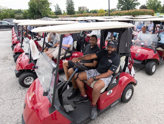 Golfers sit in red golf carts at the 2022 Center for Autism Charity Golf Outing.