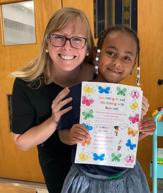 Aubree smiles with Kate Smidl, her speech therapist.