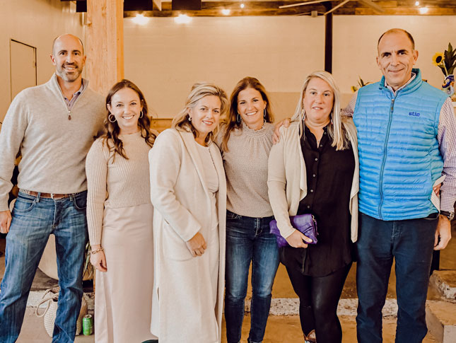 Six people pose for a group photo at Barrels & Bonfires 2022.