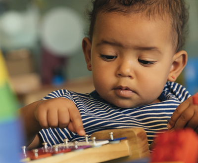 Little boy playing with instrument