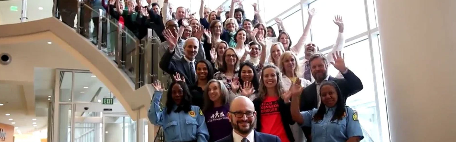 Team photo of staff standing on the stairs of our 801 building