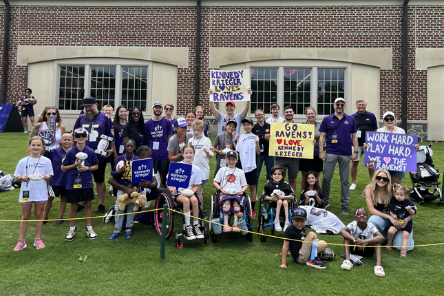 A group of Kennedy Krieger staff members and Bennett Blazers adaptive sports athletes at Ravens training camp.