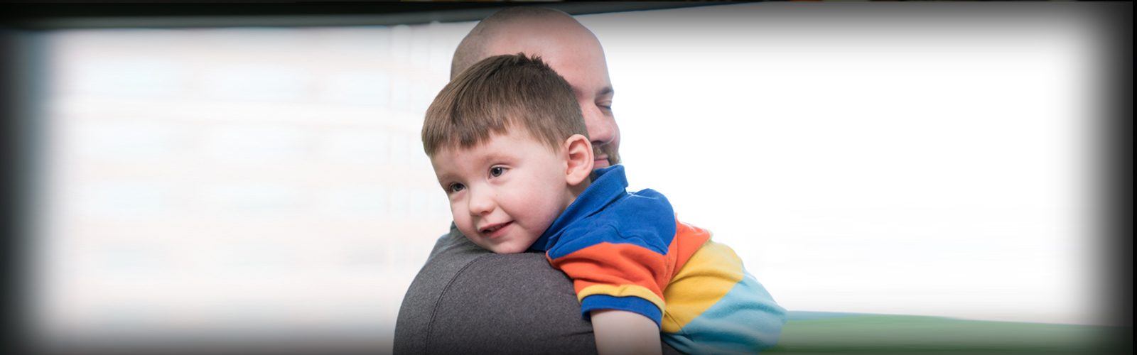 Child in embrace with his father.