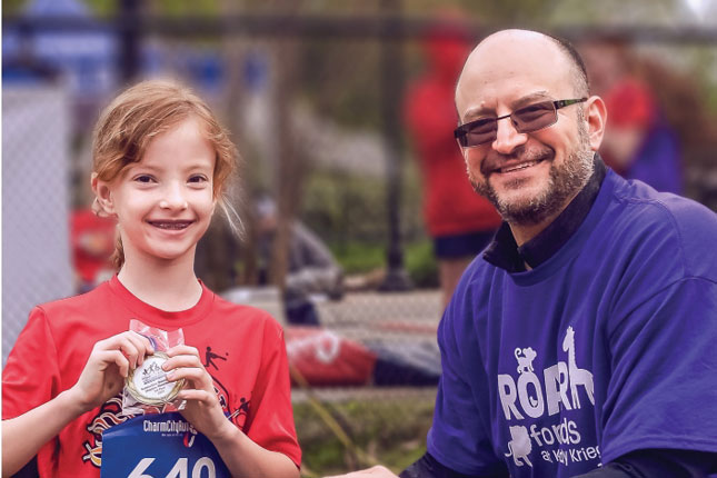 Dr. Brad Schlaggar with Dakota, an adaptive sports athlete.