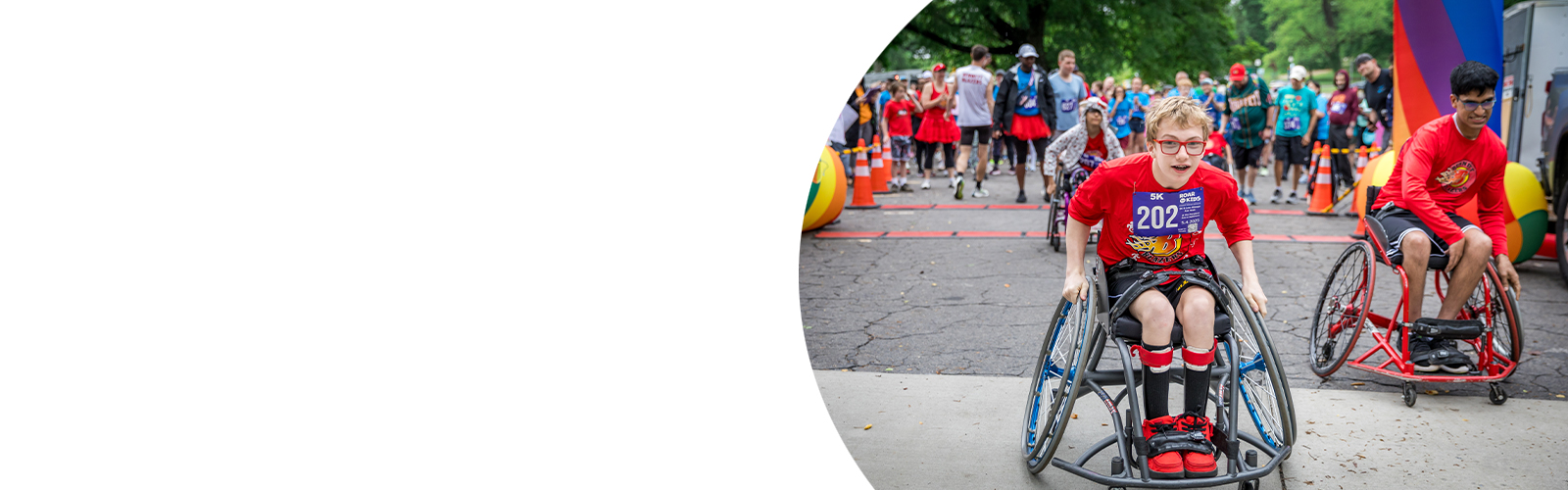 Three adaptive athletes cross the finish line at ROAR for Kids.