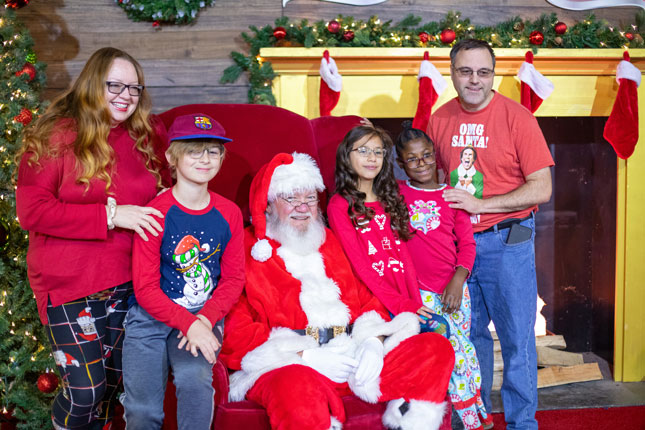 A family visits with Santa at Festival of Trees.