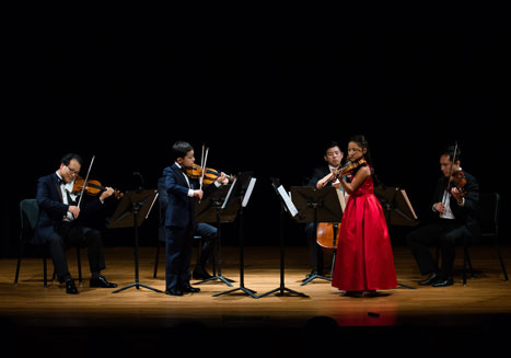 Matthew and Maggie Schneider perform on-stage. 