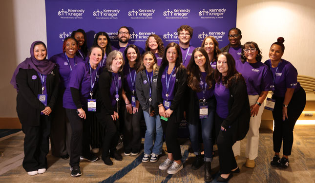 Staff members from Neurodiversity at Work smile in a group photo. 
