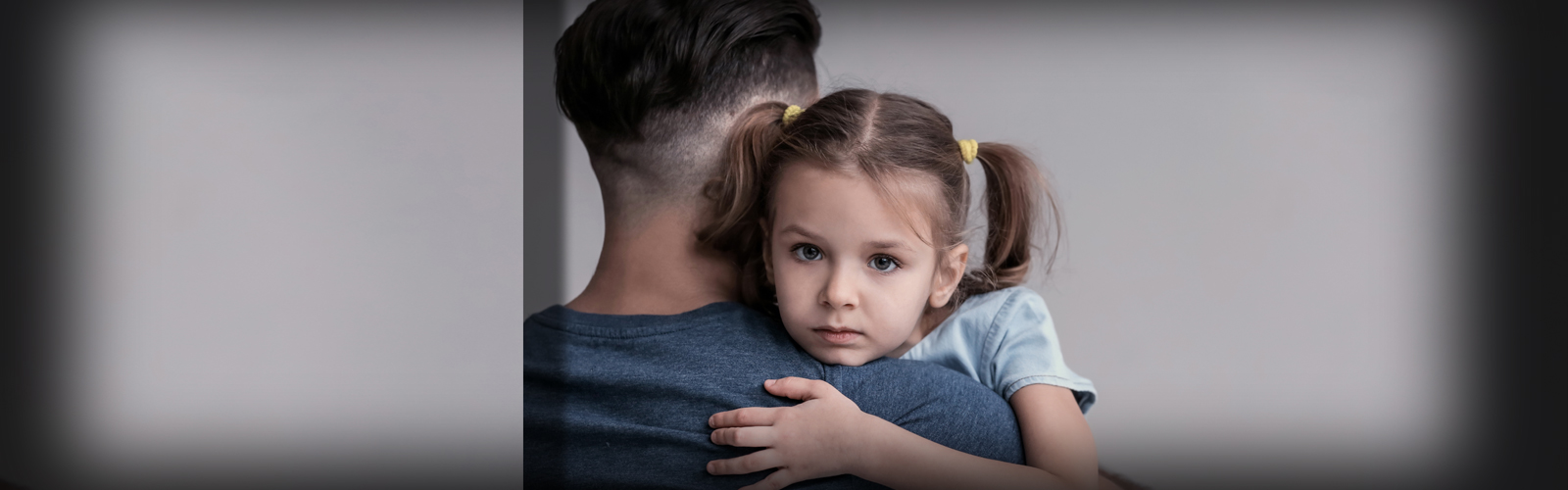 Father and daughter standing in a hallway