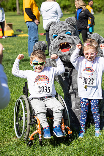 Two kids participating in the ROAR race, posing and looking strong.