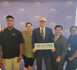 Brad Schlaggar, our CEO, stands with team members from Kennedy Krieger.