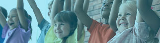 A group of children raising their hands.