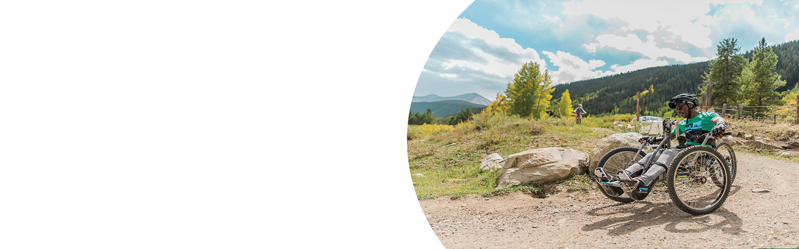 An adaptive athlete participates in a mountain biking event.