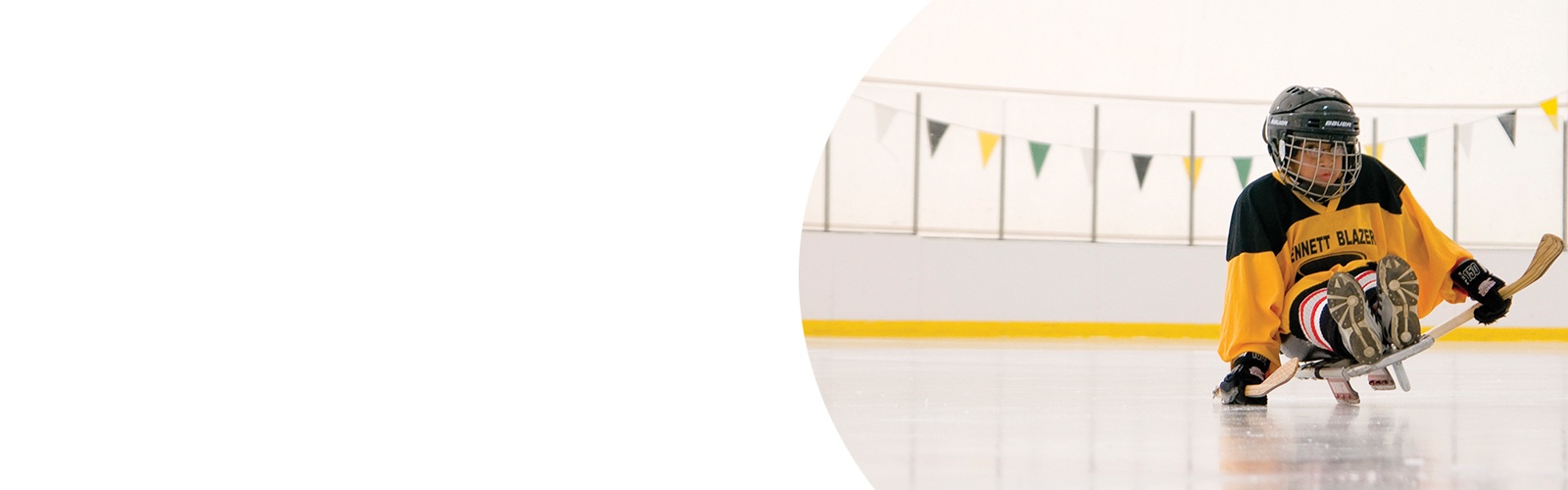 A child plays sled hockey.