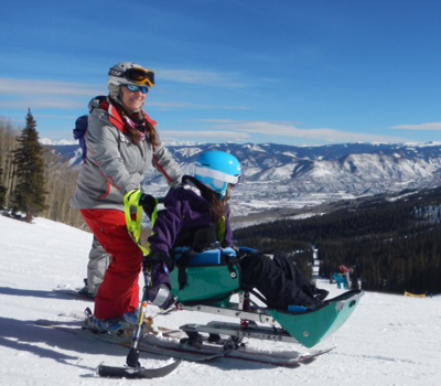 Skier using adaptive skiing device