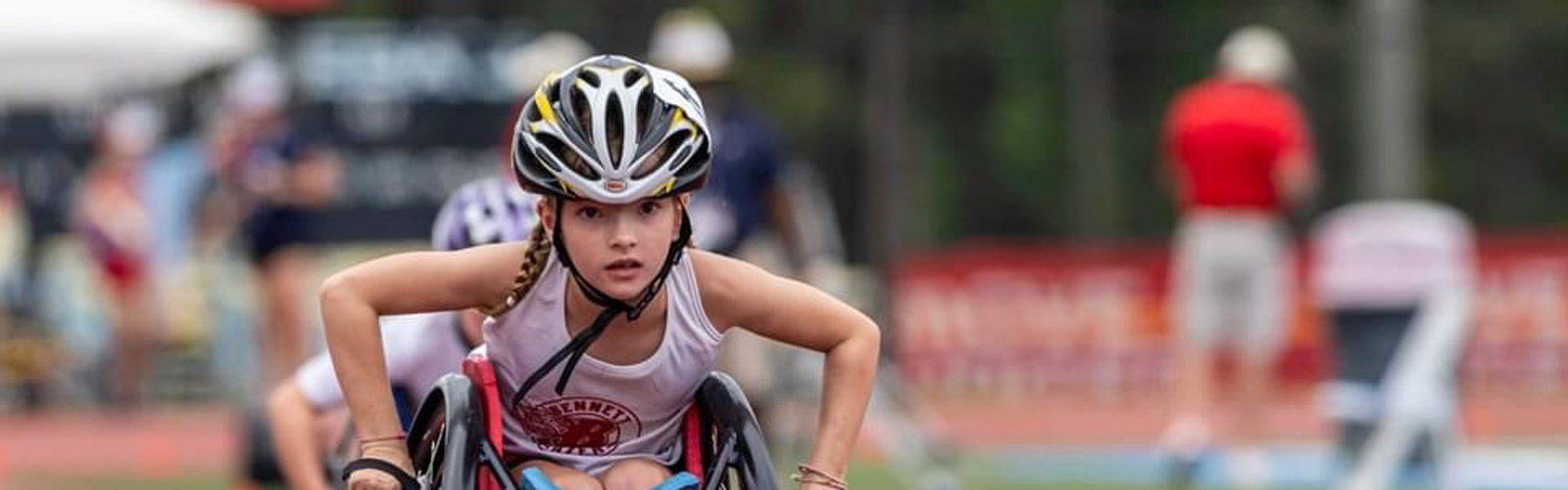 A young girl participates in an adaptive track and field race.