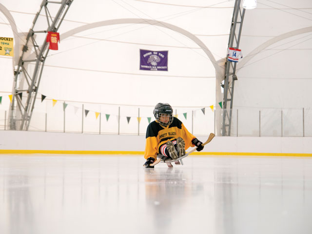 A sled hockey player on the ice.