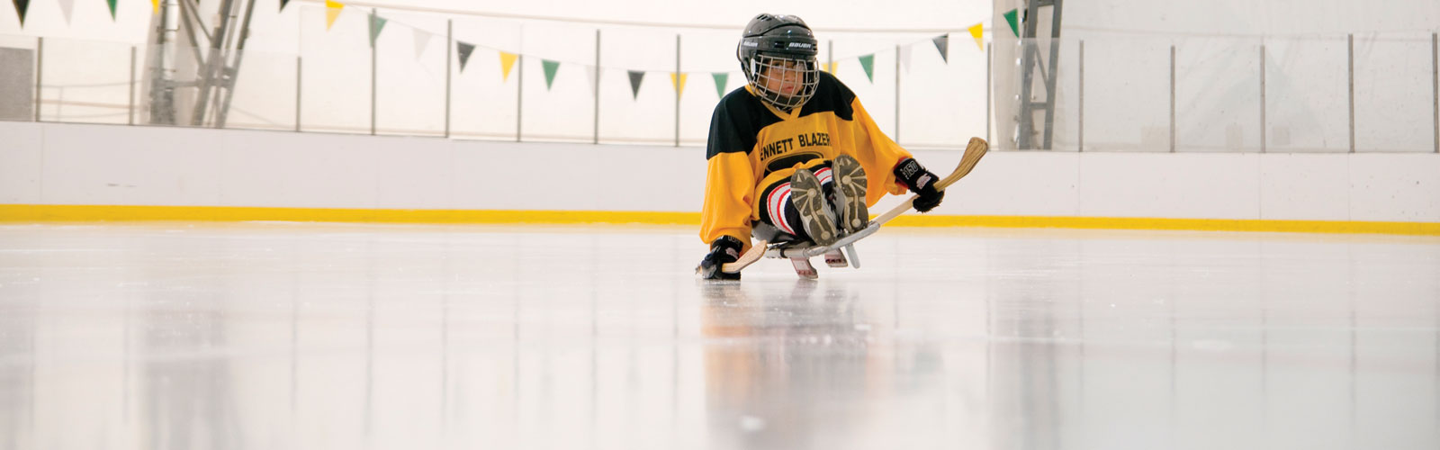 A sled hockey player on the ice. 