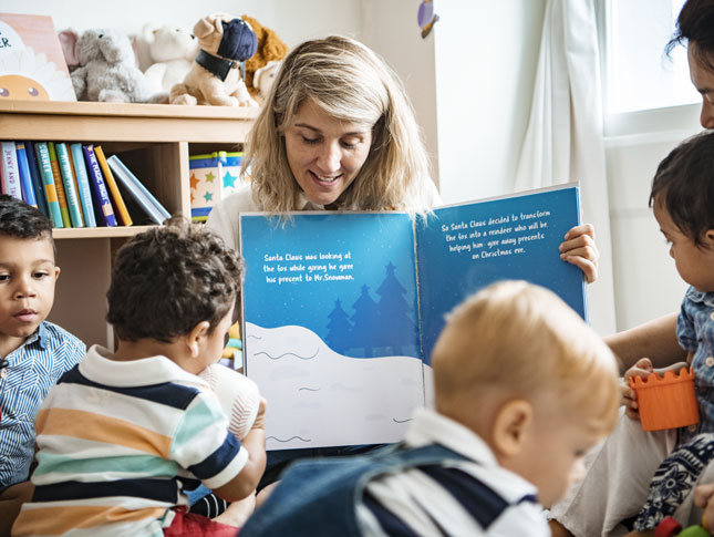 A teacher reads to a group of preschool students.