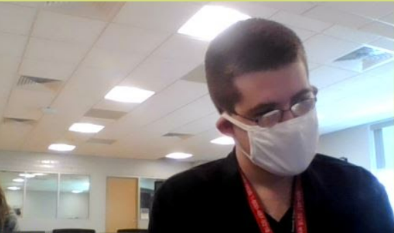 Tyler Shallue wears a mask at his job. 