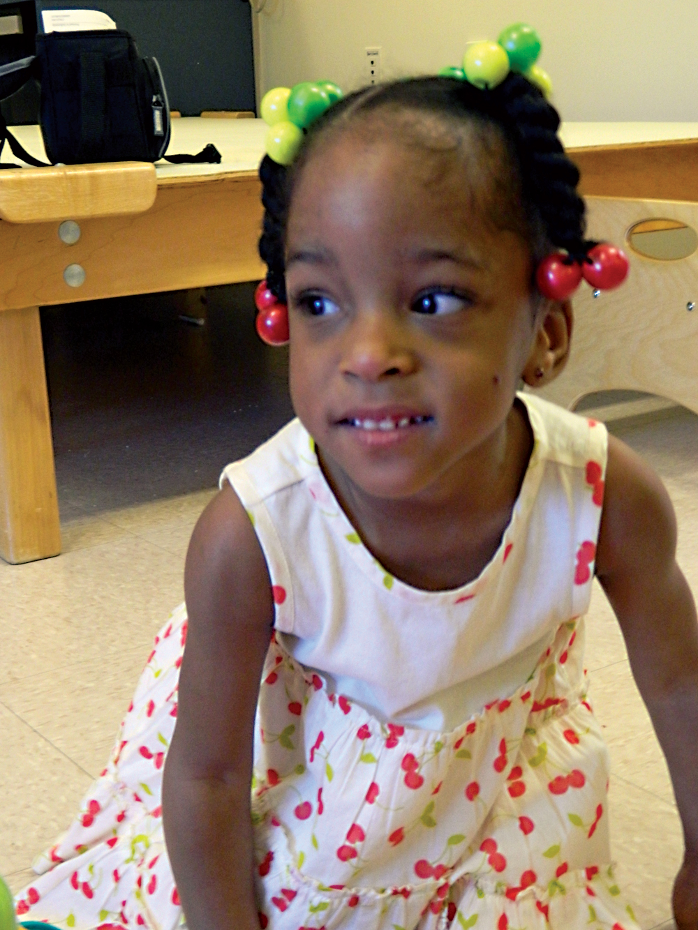 Nevaeh sitting down and smiling.