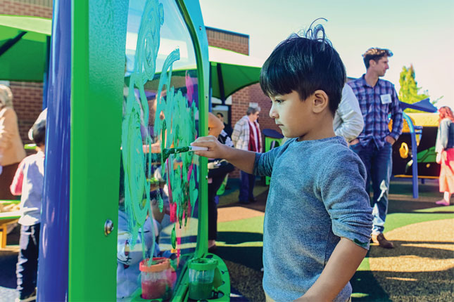 A young boy plays at the Early Childhood Development and Education Center's playground.