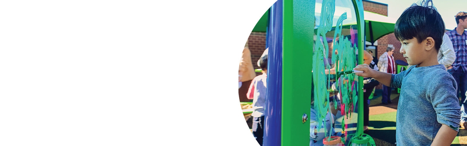 A young boy plays at the Early Childhood Development and Education Center's playground.
