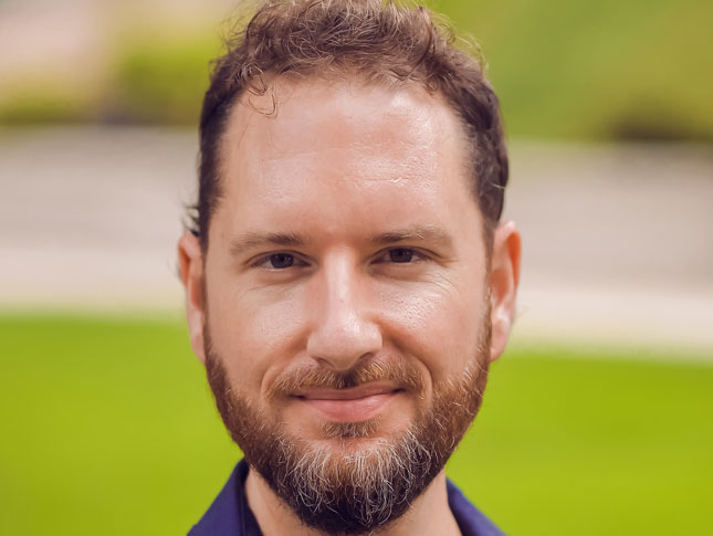 James Orman headshot. The image is taken outside.