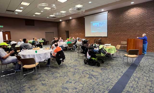 Attendees listen to a speaker during the People on the Go Quarterly meeting. 