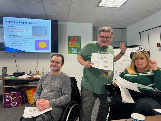 Three members of the People on the Maryland team smile while holding their Project STIR certificates. 