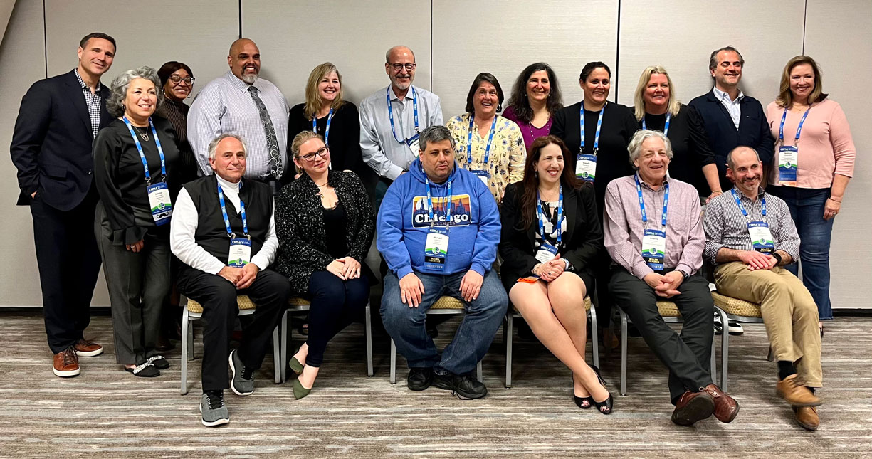 A group people pose for a photo in a conference room at the Council of Parent Attorneys and Advocates (COPAA) conference. 