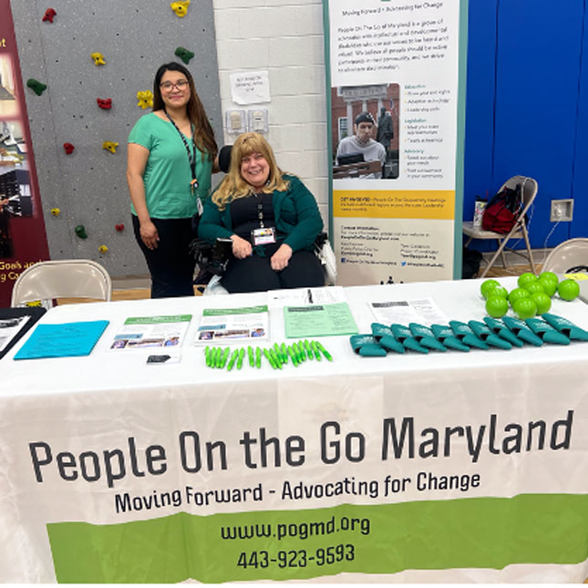 Cindy Ibarra and Tracy Wright behind the People on the Go Maryland exhibitor table at the Claremont High School Transition Fair.