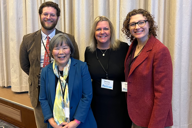 From left to right: Aaron Hauptman, Miya Asato, Maureen van Stone and Heather Riordan smile in a group photo.