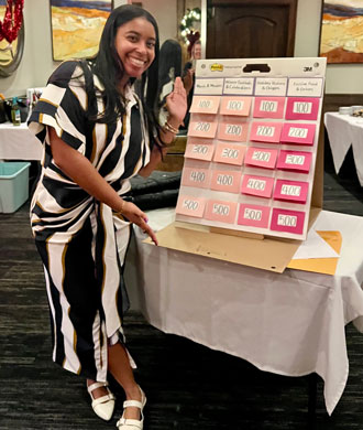 A staff member smiles at the MCDD holiday dinner.