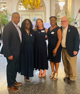 Dr. Mirian Ofonedu and three other attendees of Therapeutic Foster Care's 40th anniverary celebration.